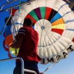 A man on a boat releasing a parasail parachute into the air | Fly-n-Float Thailand